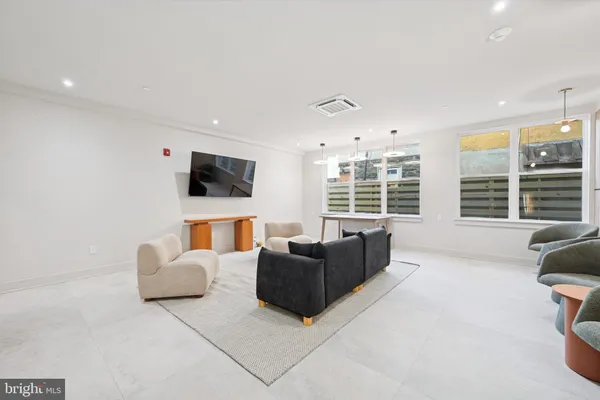 a living room with furniture window and flat screen tv