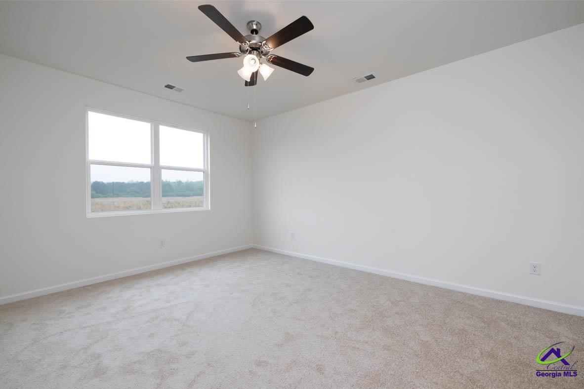 227 Cattle Drive Perry, GA 31069 - Photo 10 of 40 an empty room with a window and a fan