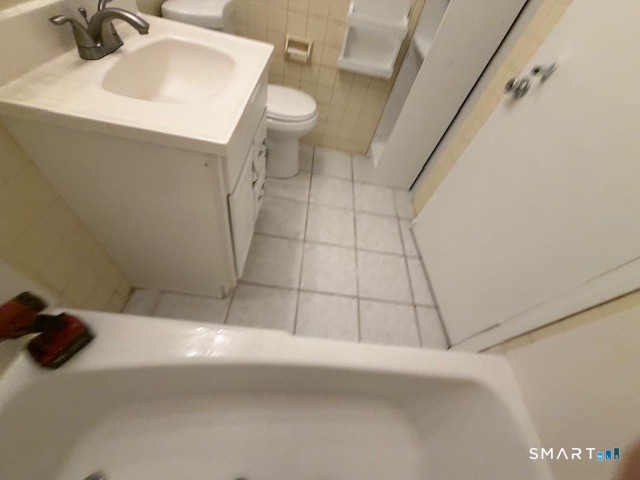 239 Old Farms Road, Unit 16D Avon, CT 06001 - Photo 8 of 16 a bathroom with a sink a toilet and a mirror
