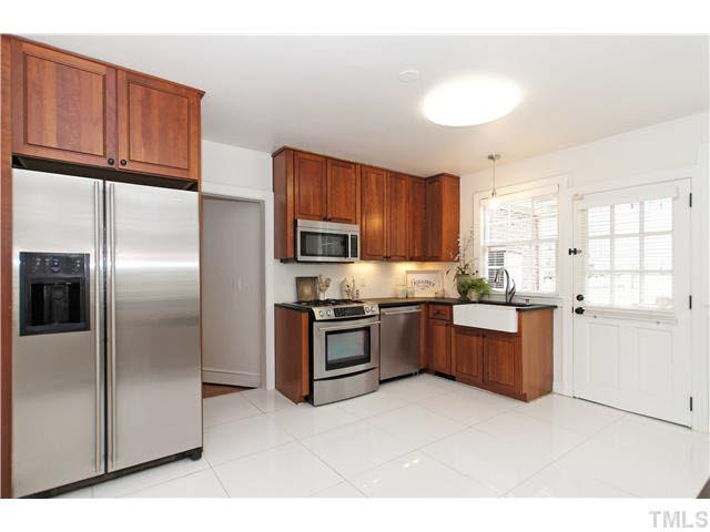 517 Gardner Street Raleigh, NC 27607 - Photo 6 of 21 Completely (and beautifully) renovated kitchen includes cherry cabinets, hand made marble counters, terrazzo tile flooring and all stainless appliances (jenn air microwave, dishwasher), gas range and side by side refrigerator.
