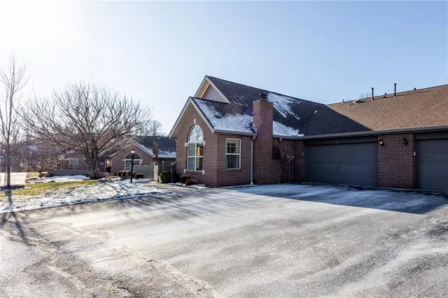 a view of a houses with snow on the road