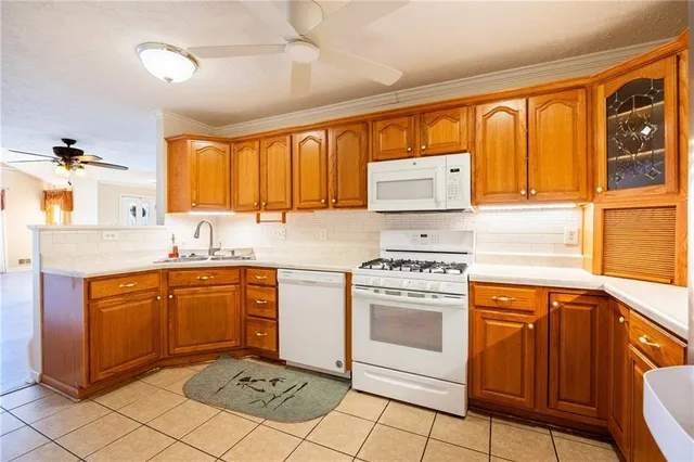 a kitchen with stainless steel appliances granite countertop a stove sink and cabinets