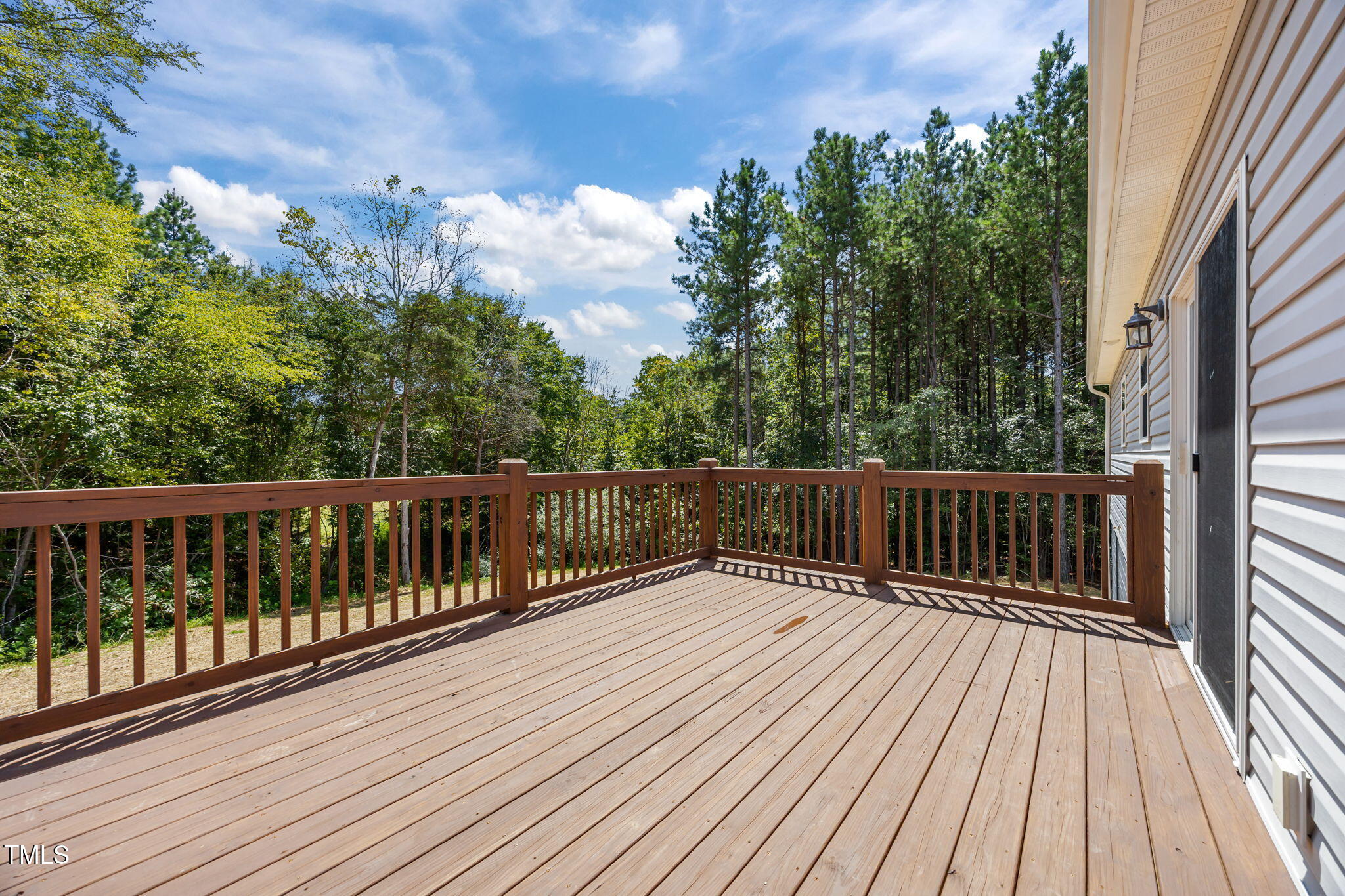 6033 David Moore Road Burlington, NC 27217 - Photo 26 of 30 Large back deck overlooking treelined yard.