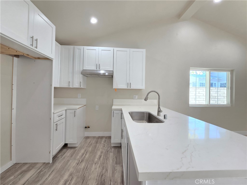 3871 Bandini Avenue Riverside, CA 92506 - Photo 5 of 11 a kitchen with a sink a refrigerator and cabinets