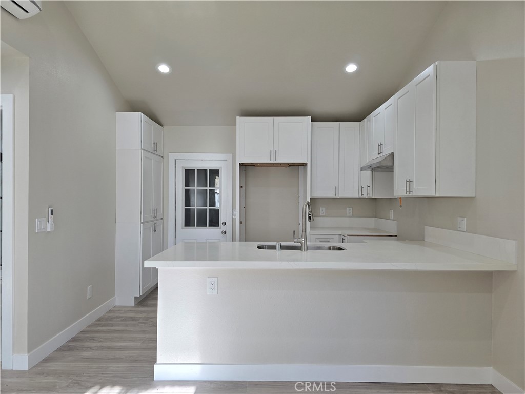 3871 Bandini Avenue Riverside, CA 92506 - Photo 7 of 11 a close view of kitchen countertops with cabinets and wooden floor