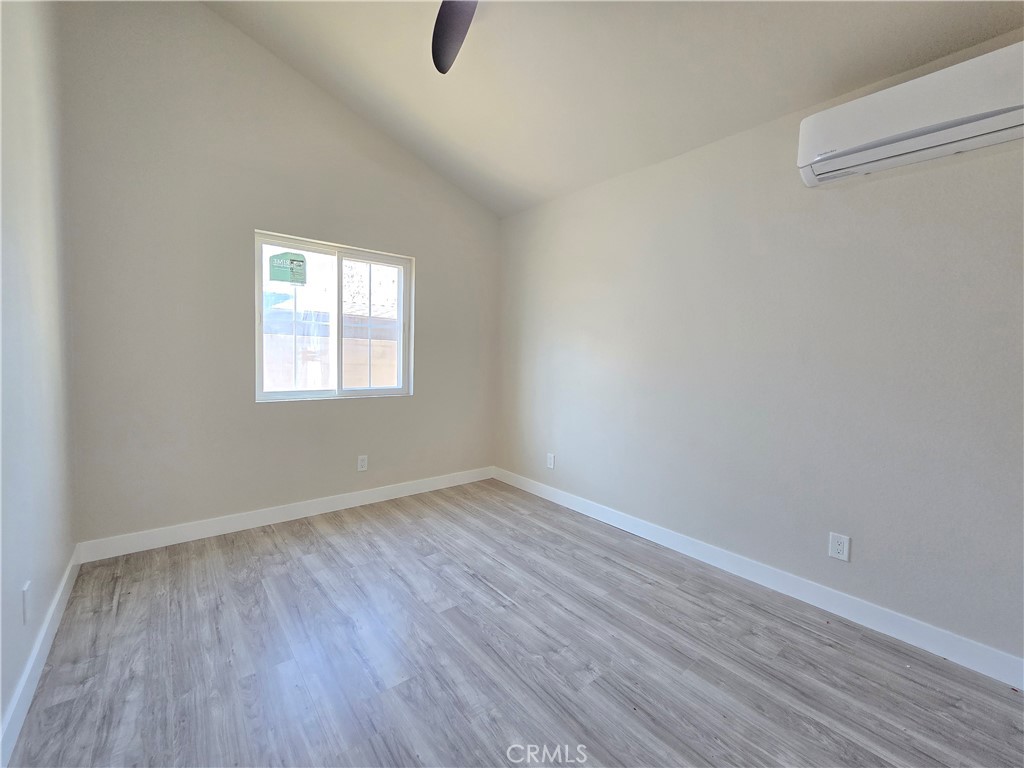 3871 Bandini Avenue Riverside, CA 92506 - Photo 10 of 11 an empty room with wooden floor and windows