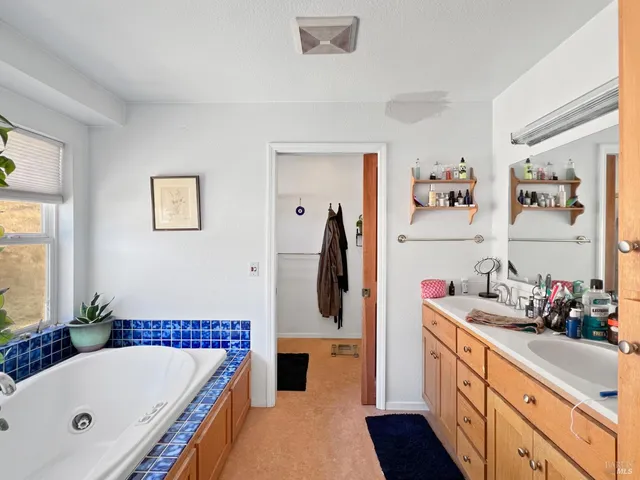 a bathroom with a tub and a shower