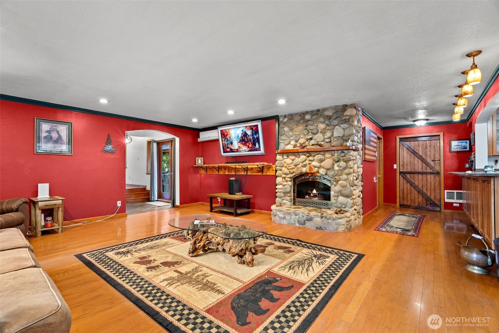 4914 182nd Avenue Southwest Longbranch, WA 98351 - Photo 15 of 37 a living room with furniture a rug and a fireplace