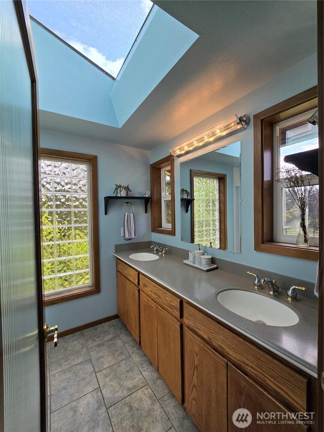 4914 182nd Avenue Southwest Longbranch, WA 98351 - Photo 25 of 37 a bathroom with a granite countertop sink and a mirror