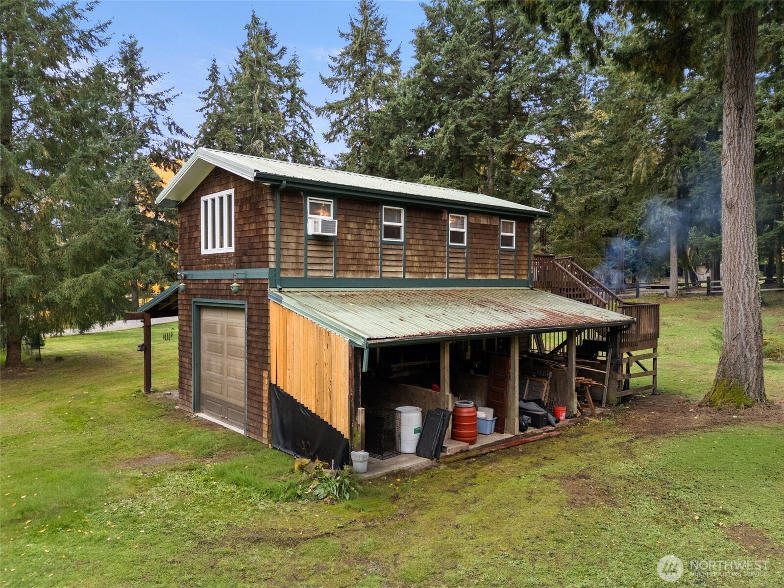 4914 182nd Avenue Southwest Longbranch, WA 98351 - Photo 28 of 37 a view of a house with a yard chairs and a roof deck