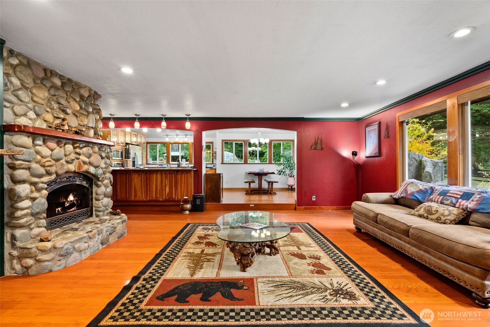 4914 182nd Avenue Southwest Longbranch, WA 98351 - Photo 7 of 37 a living room with fireplace furniture and a large window