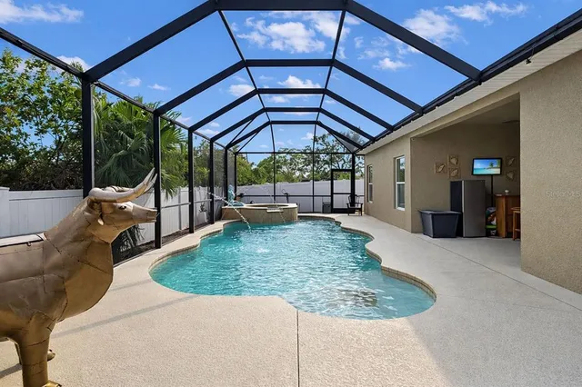 a view of a backyard with table and chairs under an umbrella