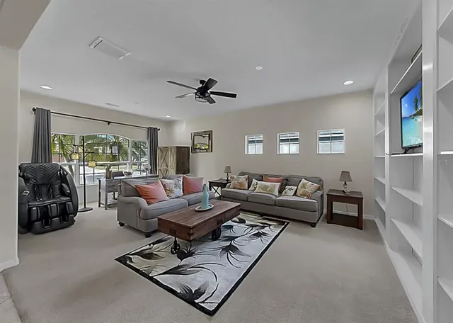a living room with furniture a large window and gym equipment