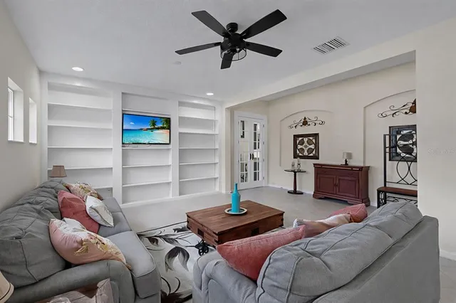 a living room with furniture and a wooden floor