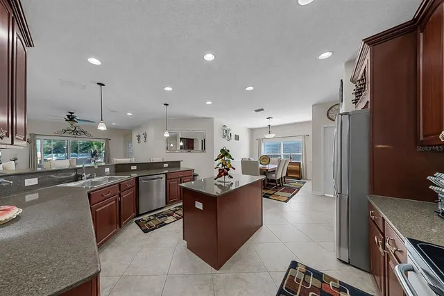 a kitchen view with stainless steel appliances granite countertop a lot of counter top space