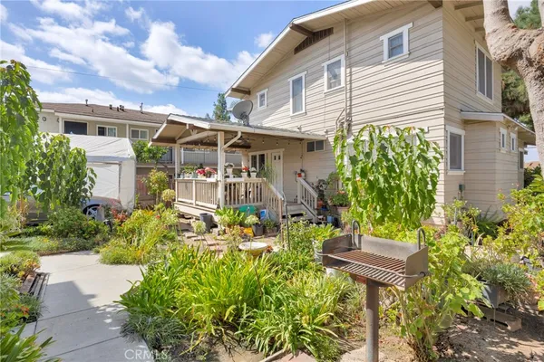 a view of a house with potted plants