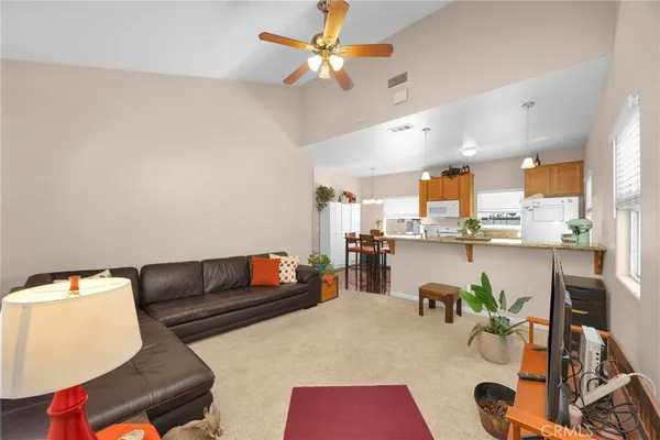 a kitchen with a table chairs sink and cabinets