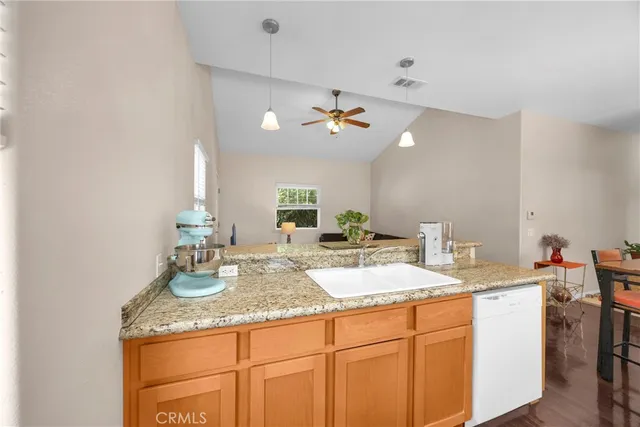 a bathroom with a granite countertop sink toilet tub and shower