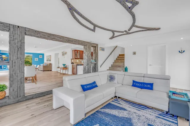 a view of a dining room with furniture a rug and wooden floor