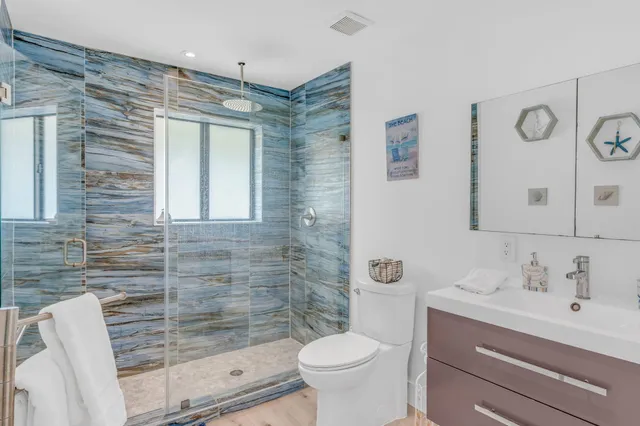 a bedroom with a large window and a bed