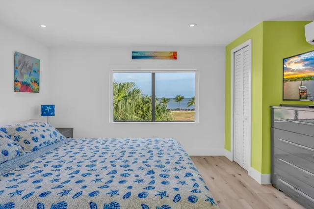 a bedroom with a dresser and a shower