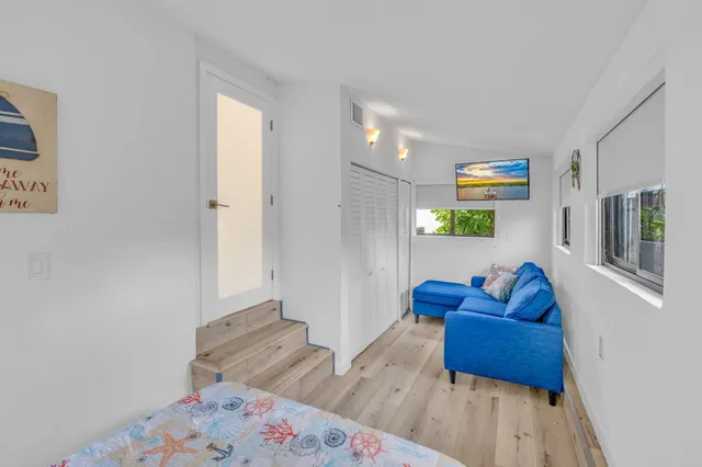 a view of a patio with a table and chairs under an umbrella