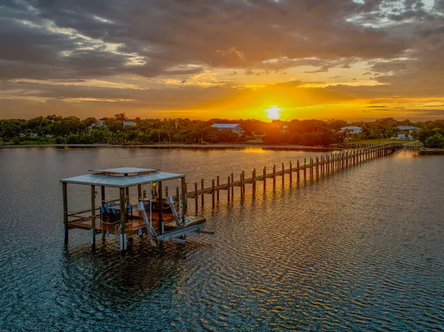 a view of a house with swimming pool and porch with furniture