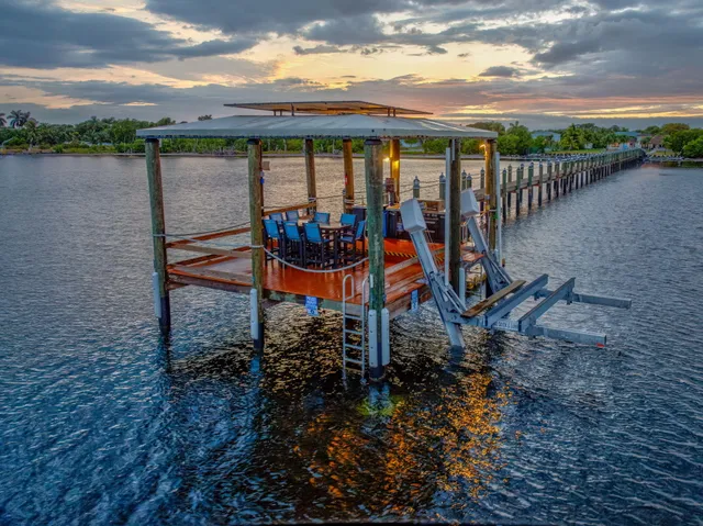 a view of deck with table and chairs