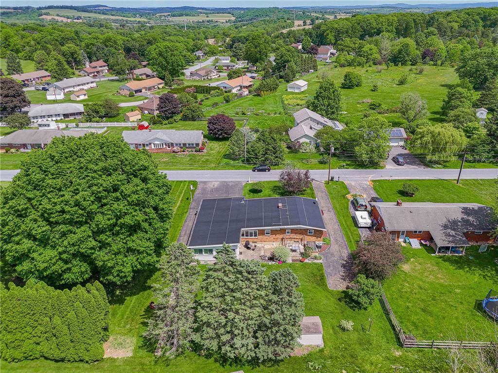 579 Cherry Road Northampton, PA 18067 - Photo 55 of 57 An aerial perspective reveals a charming residential neighborhood set against a backdrop of rolling, tree-covered green space.