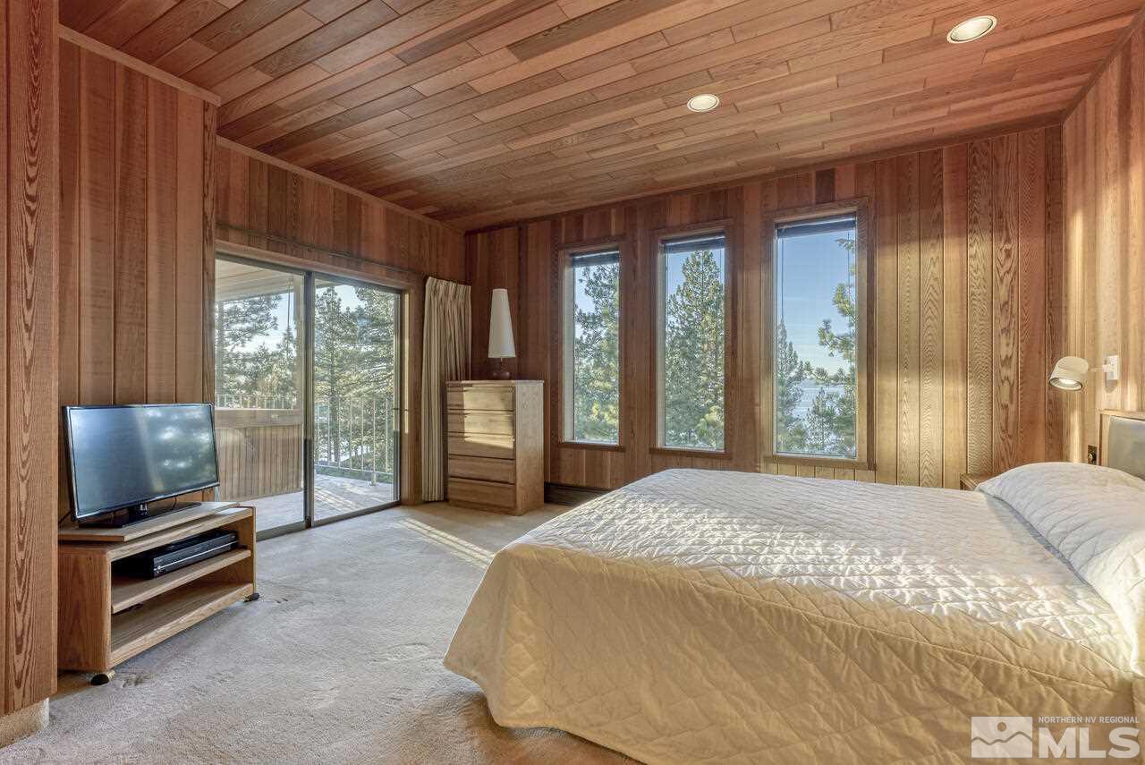 118 Ponderosa Zephyr Cove, NV 89448 - Photo 18 of 31 a spacious bedroom with a large bed and a flat tv screen