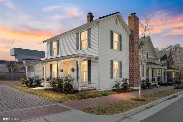 a front view of a house with yard and garage