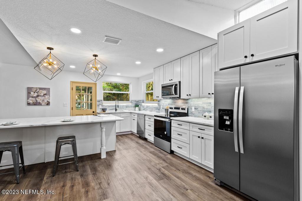 17 River Road Orange Park, FL 32073 - Photo 12 of 49 a kitchen with white cabinets and stainless steel appliances