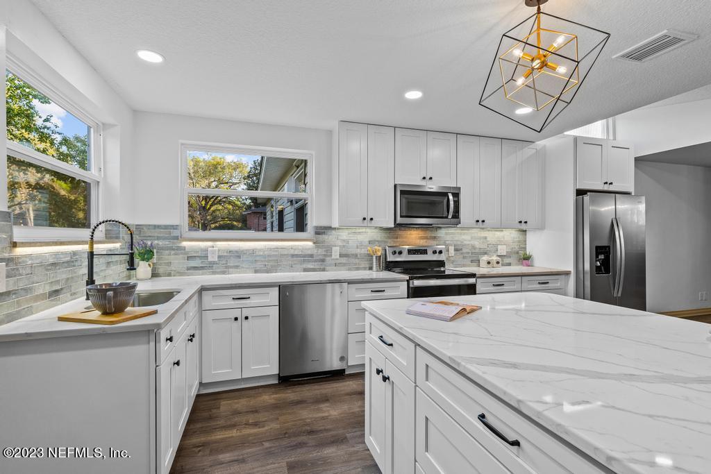 17 River Road Orange Park, FL 32073 - Photo 16 of 49 a kitchen with a sink stove and refrigerator