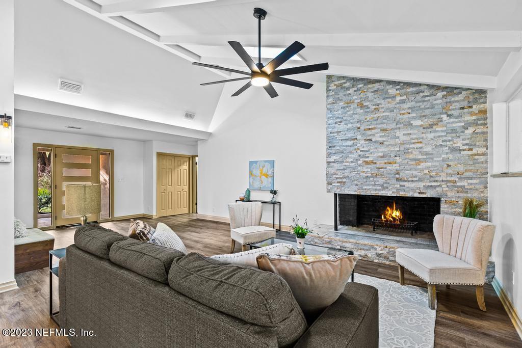 17 River Road Orange Park, FL 32073 - Photo 19 of 49 a living room with furniture a fireplace and a flat screen tv