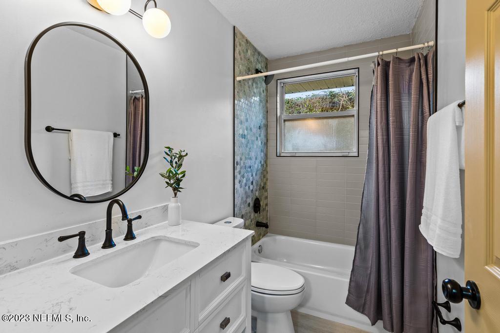 17 River Road Orange Park, FL 32073 - Photo 24 of 49 a bathroom with a sink a toilet and a mirror