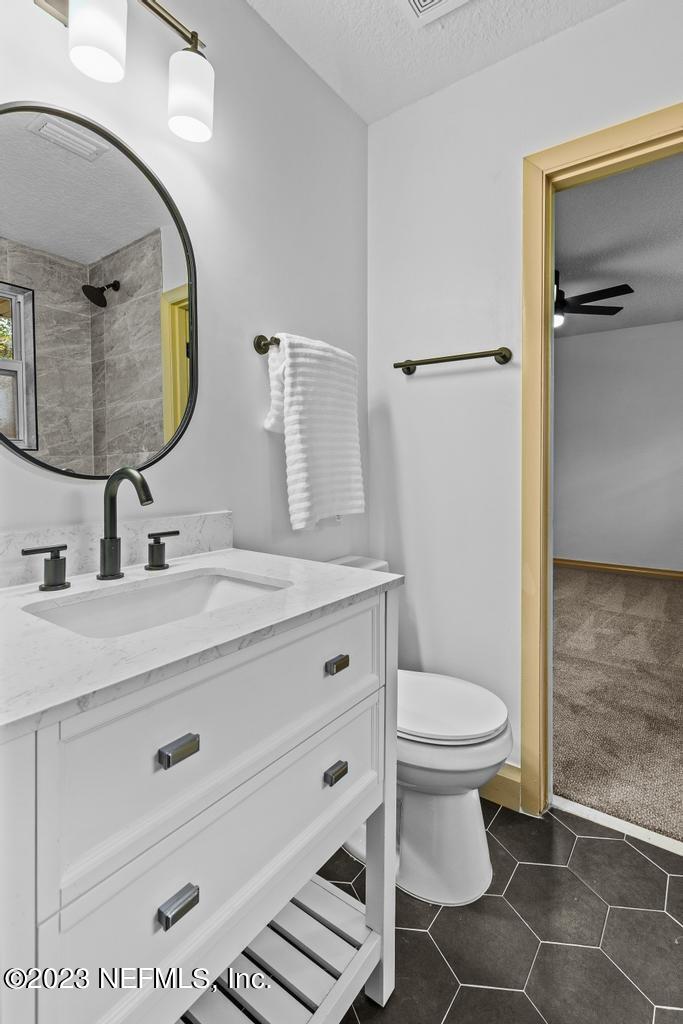 17 River Road Orange Park, FL 32073 - Photo 30 of 49 a bathroom with a sink mirror vanity and toilet