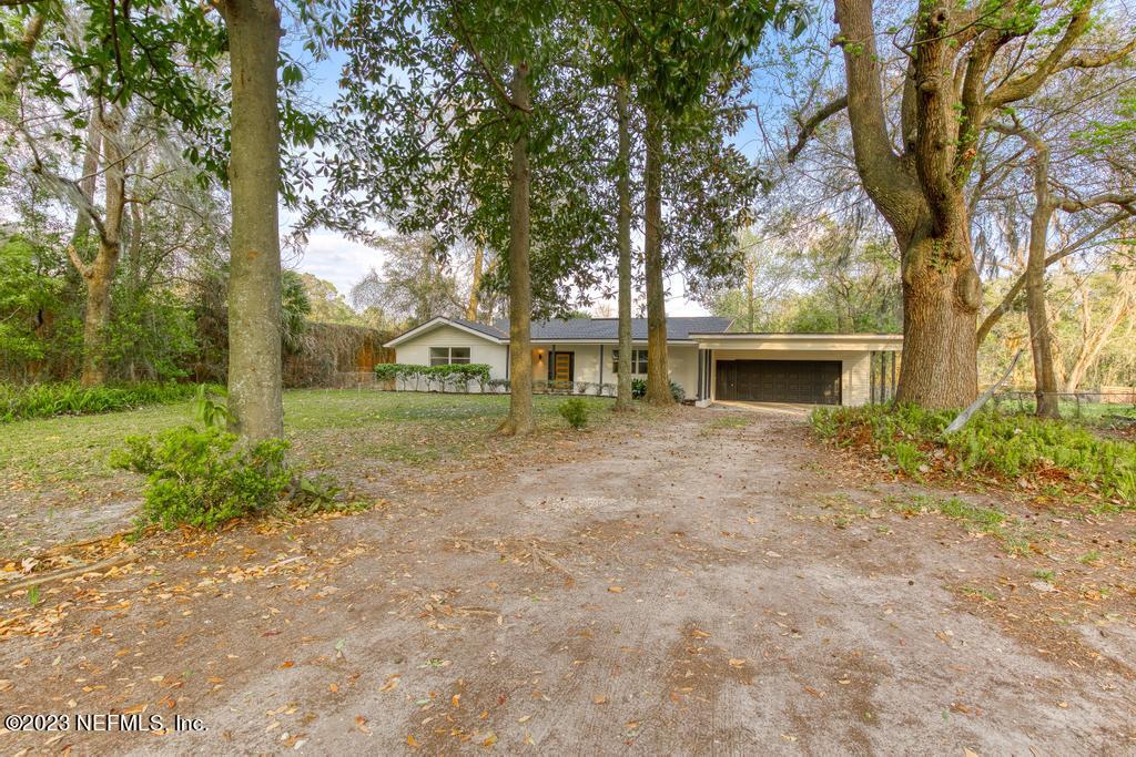 17 River Road Orange Park, FL 32073 - Photo 3 of 49 a view of house with trees in front of it