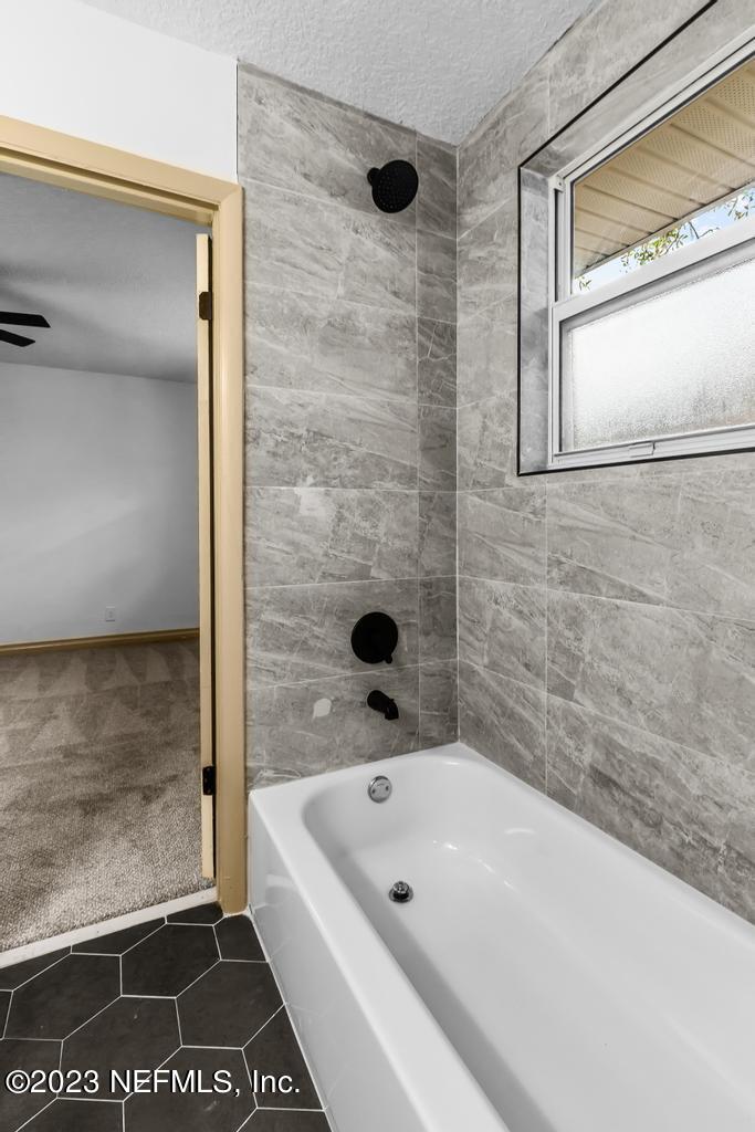 17 River Road Orange Park, FL 32073 - Photo 31 of 49 a bathroom with a tub shower and a sink