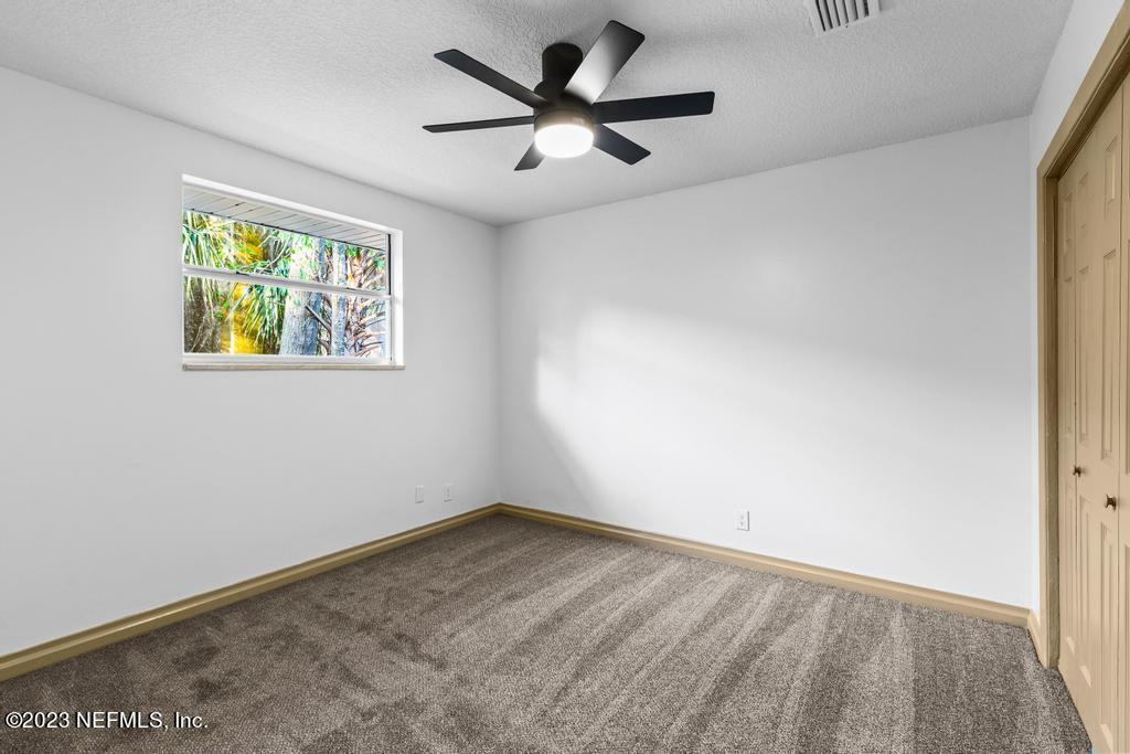 17 River Road Orange Park, FL 32073 - Photo 32 of 49 an empty room with a window and a ceiling fan