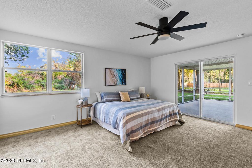 17 River Road Orange Park, FL 32073 - Photo 33 of 49 a spacious bedroom with a bed and window