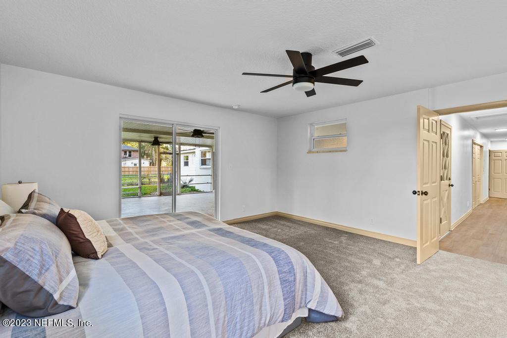 17 River Road Orange Park, FL 32073 - Photo 34 of 49 a bedroom with a large bed and a ceiling fan