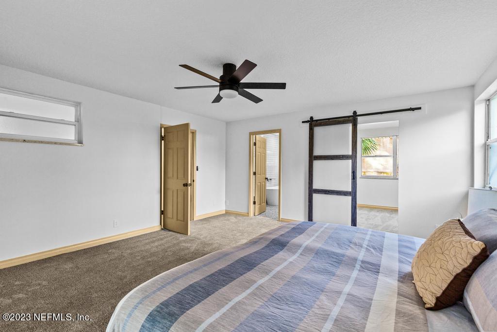 17 River Road Orange Park, FL 32073 - Photo 35 of 49 a bedroom with a bed and a chandelier