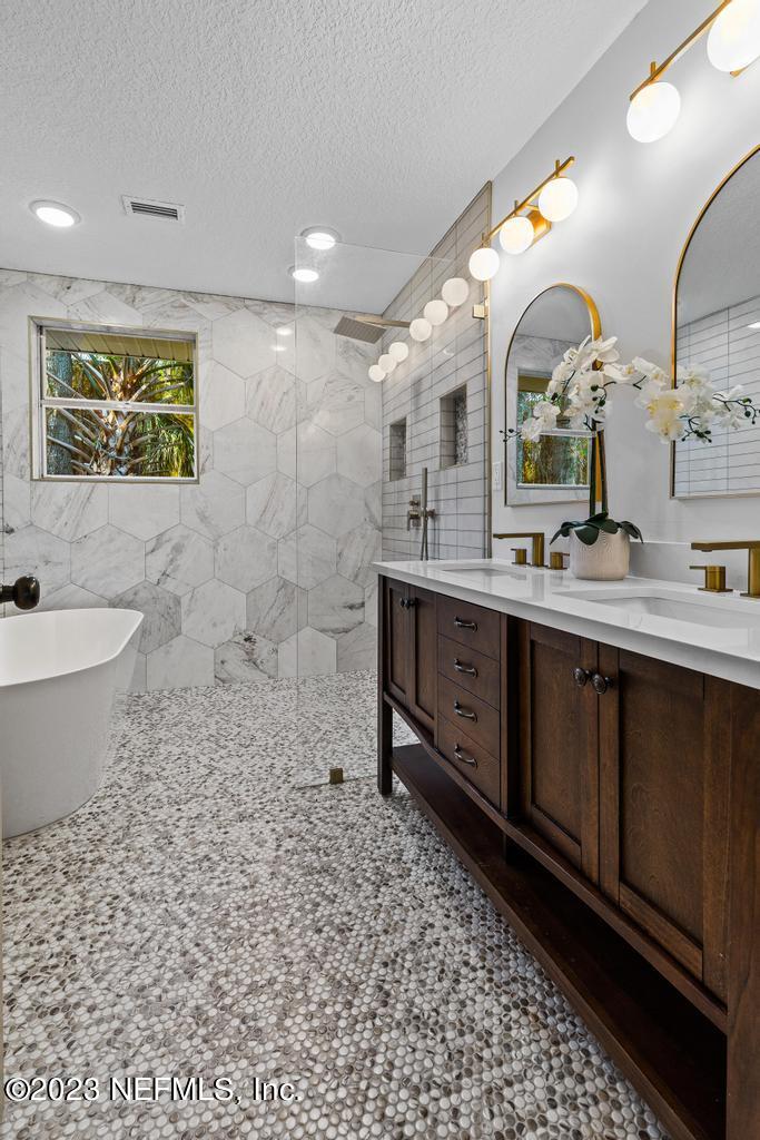 17 River Road Orange Park, FL 32073 - Photo 39 of 49 a bathroom with a double vanity sink a mirror and a bathtub