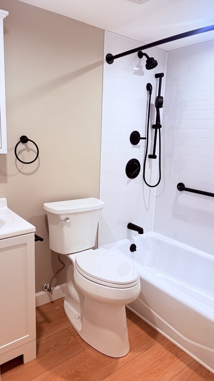 49 Melrose Street, Unit 1H Melrose, MA 02176 - Photo 14 of 20 a white toilet sitting next to a bathroom sink