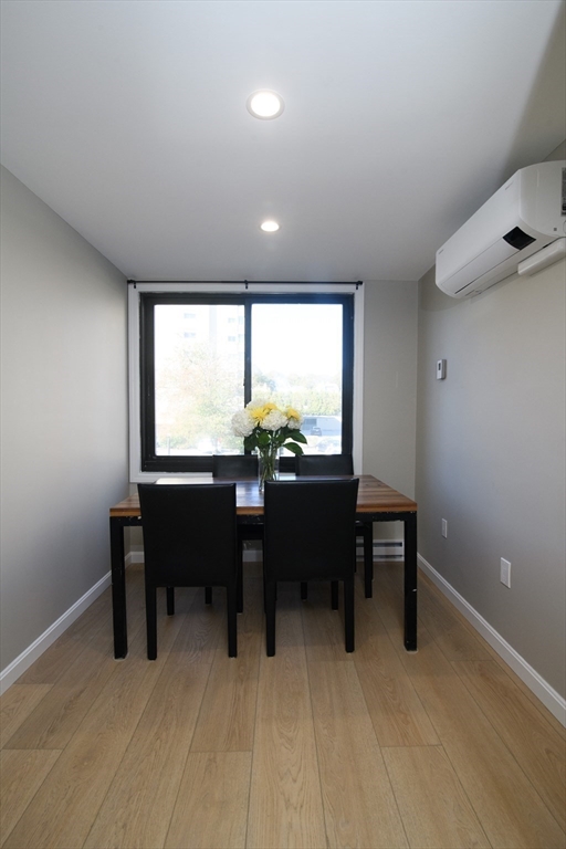 49 Melrose Street, Unit 1H Melrose, MA 02176 - Photo 4 of 20 a view of a big room with wooden floor and furniture