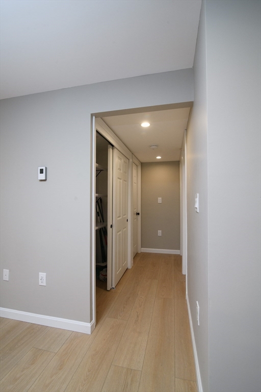 49 Melrose Street, Unit 1H Melrose, MA 02176 - Photo 8 of 20 a view of hallway with closet and a white wall