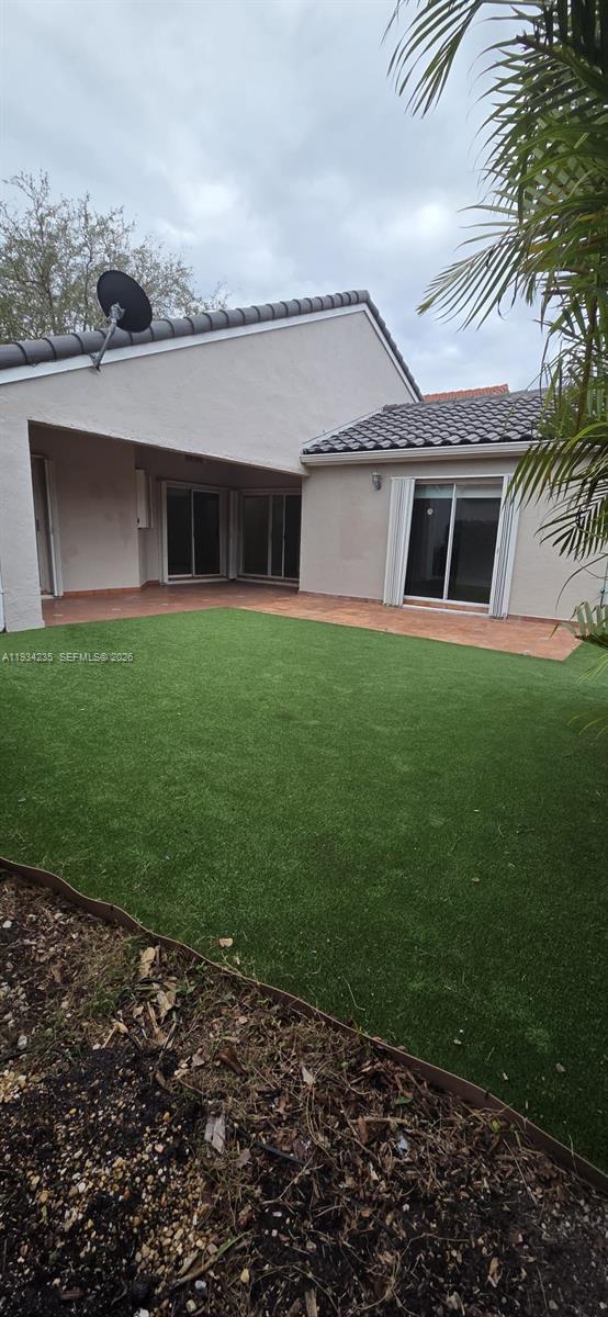 11787 Southwest 90th Terrace, Unit 11787 Miami, FL 33186 - Photo 17 of 17 a front view of a house with a yard