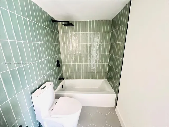 a white and white bathroom with a sink