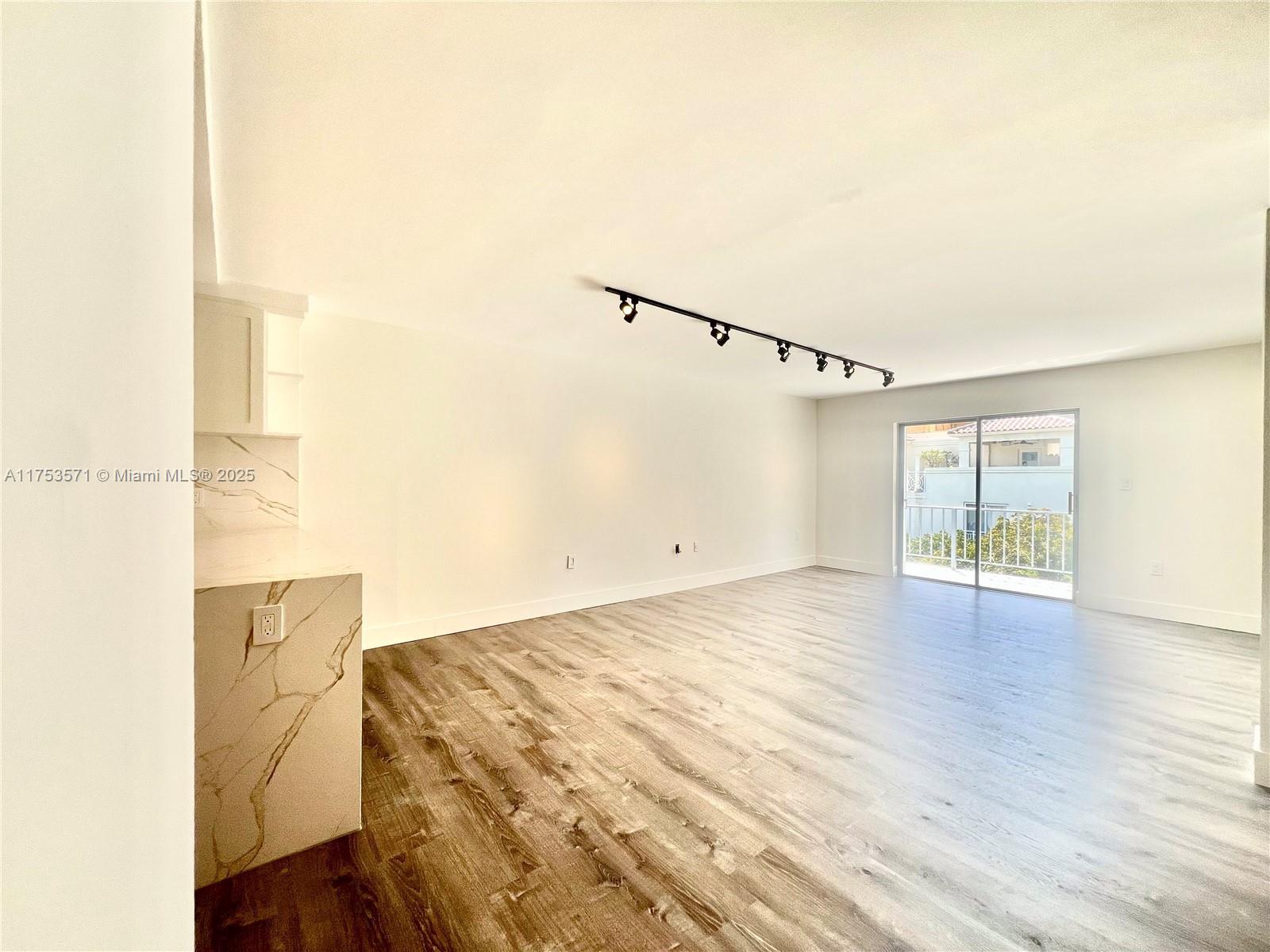 201 Jefferson Avenue, Unit 4C Miami Beach, FL 33139 - Photo 20 of 35 a view of empty room with wooden floor