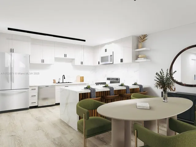 a kitchen with a white cabinets and chairs